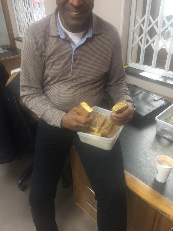 Lenn Mayhew Lewis with gold bars