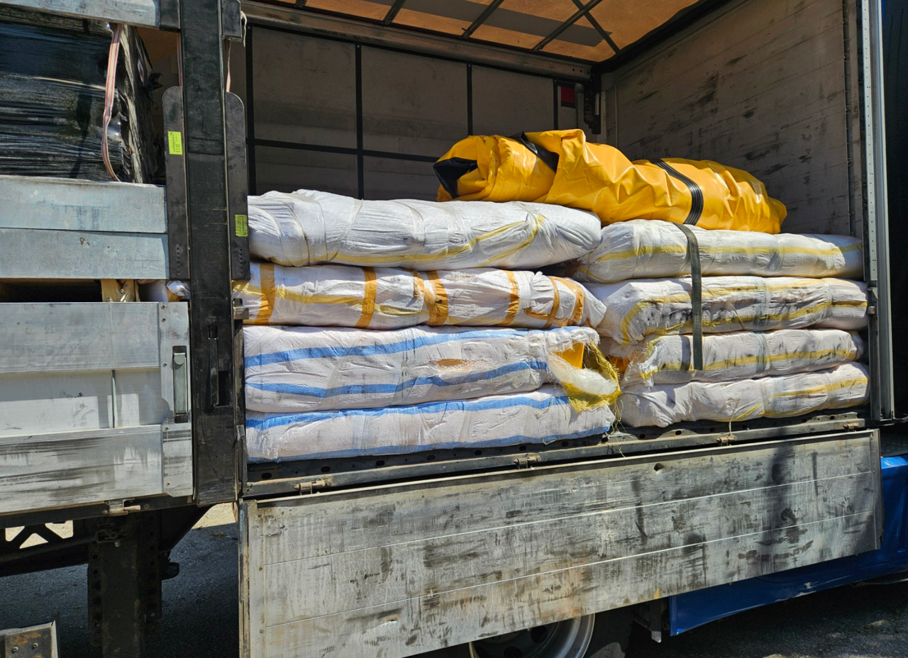 Stack of packaged inflatable boats inside the back of a lorry