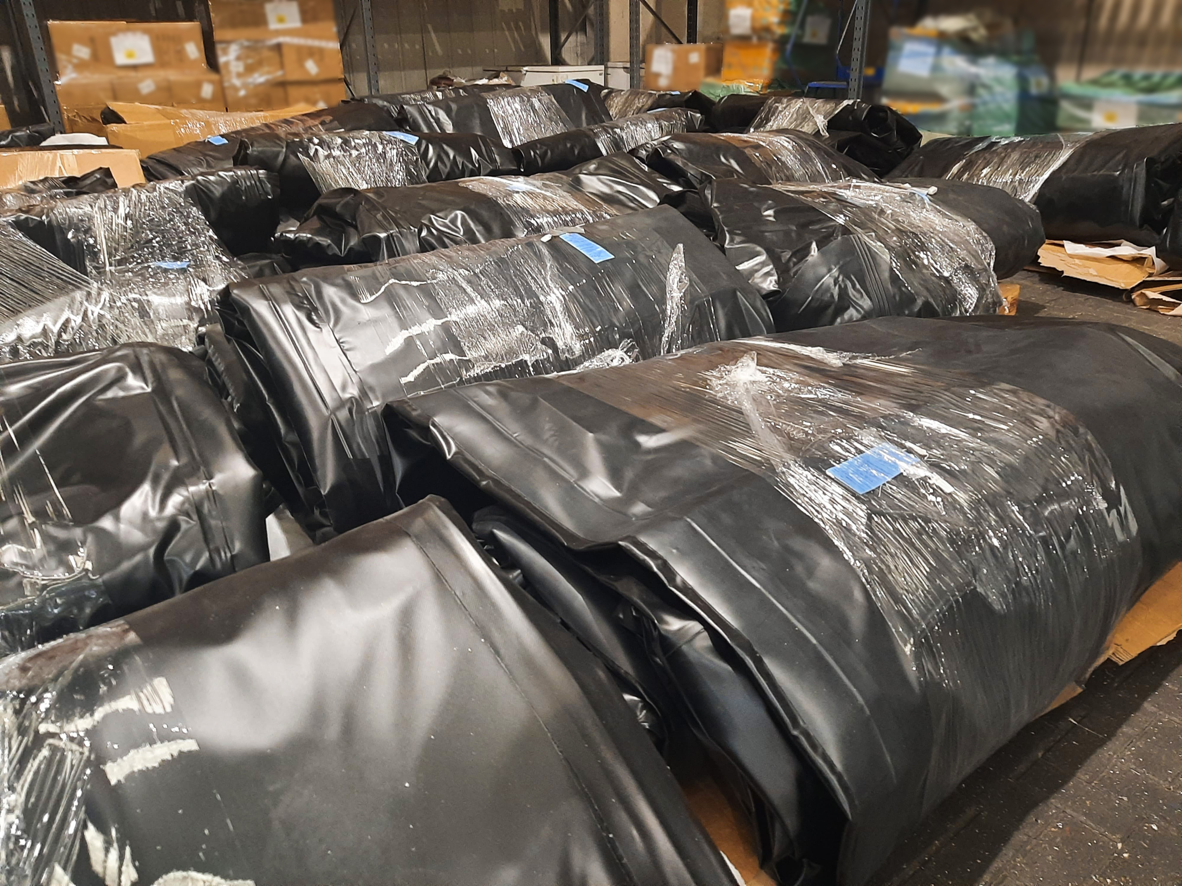Black rubber boats pilled up together