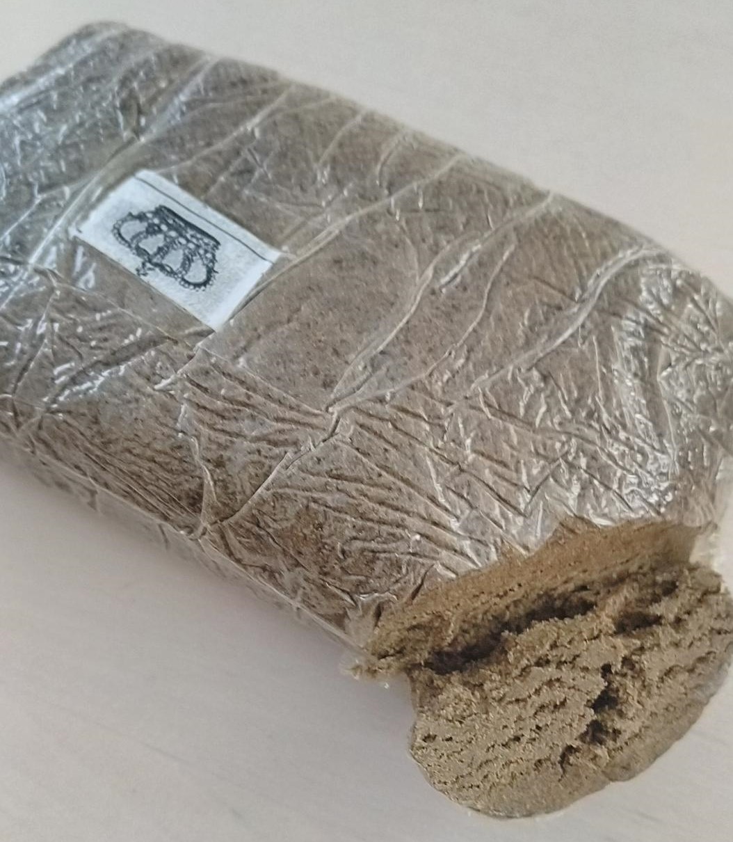 Package of cannabis with one end cut off to show contents