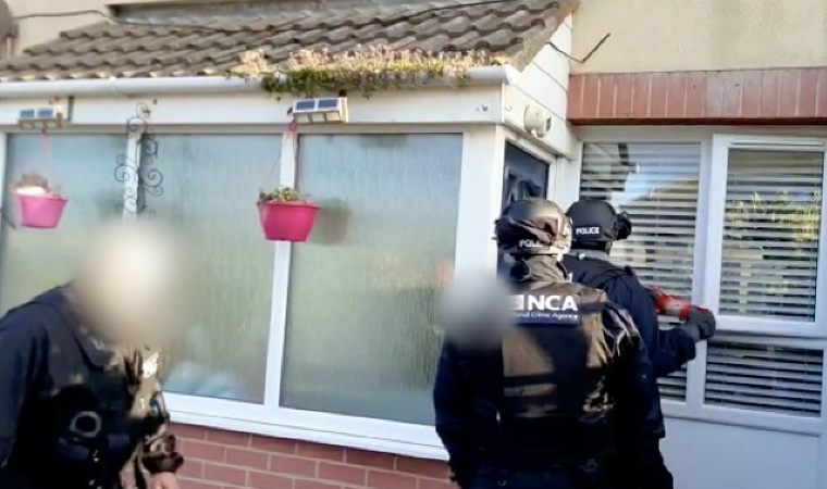 officers striking down suspect's door