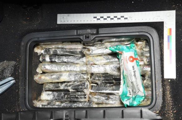 A stash of firearms concealed within the vehicle's flooring.